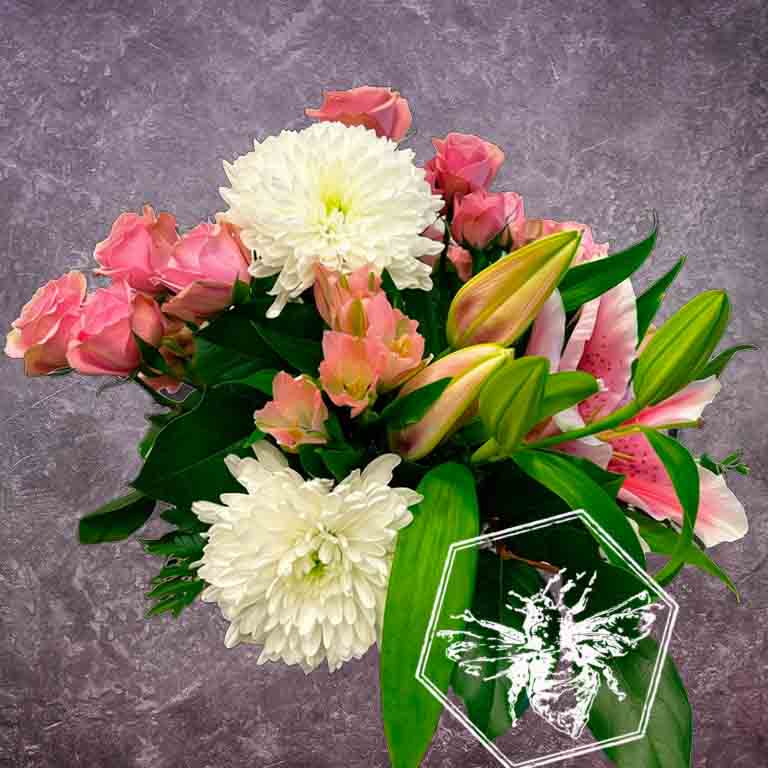 Fresh lilies arranged in a ceramic pot with other season flowers perfect for any occasion
