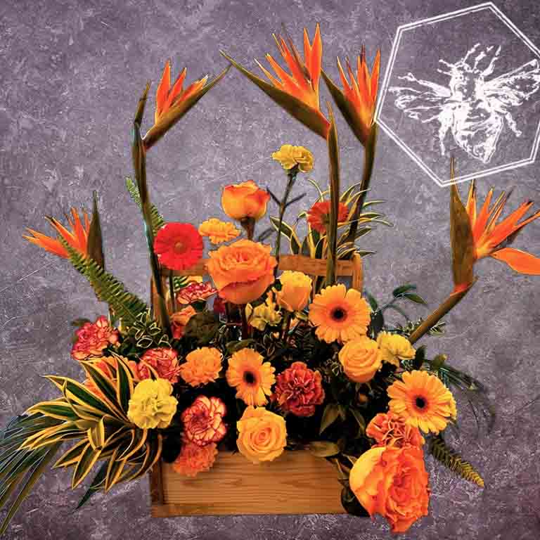Creative fresh modern arranged tropical birds of paradise arranged with an assortment of complimentary flowers with greens and beautiful elevated accents
