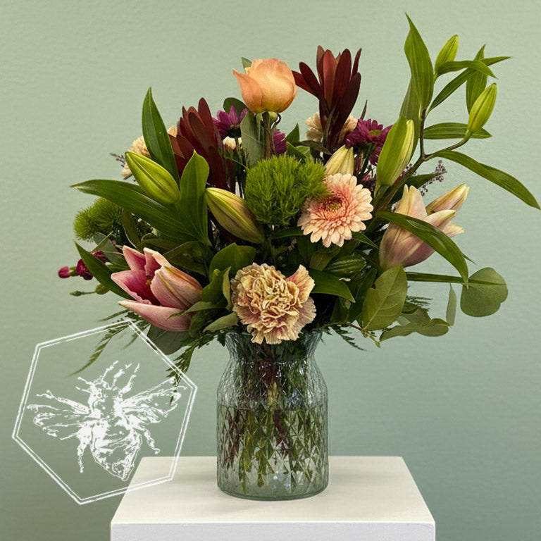 Fresh assorted flowers arranged in a traditional vase