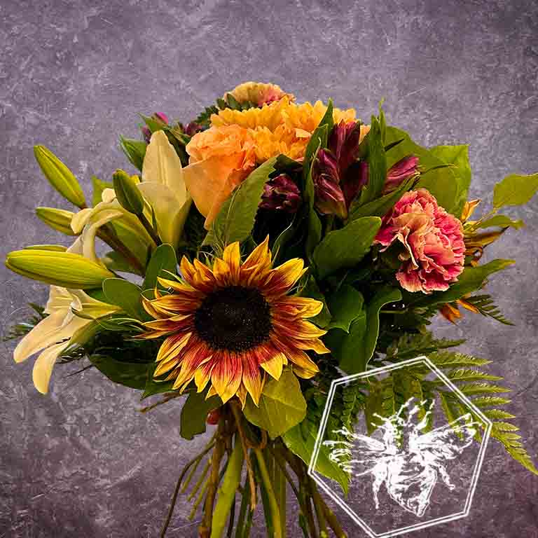 Bouquet of flowers with sunflower, lilies, and carnations on a gray background