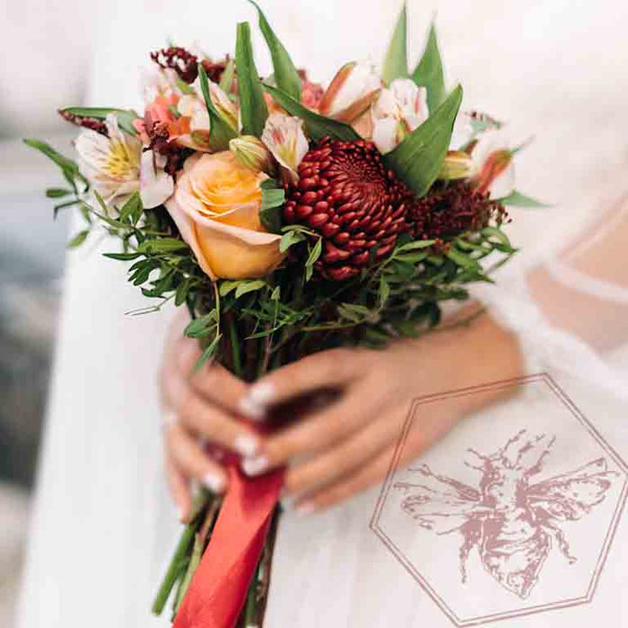 Bridal bouquet featuring roses and burgundy mums by The B Nest