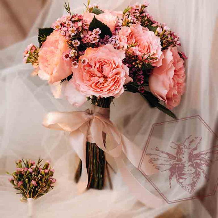 High petal count pink garden roses bridal bouquet with matching boutonniere by The B Nest Studios