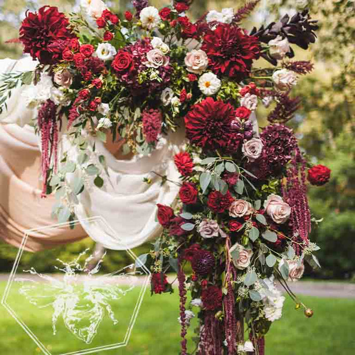 Red, white and burgundy wedding arch corner florals