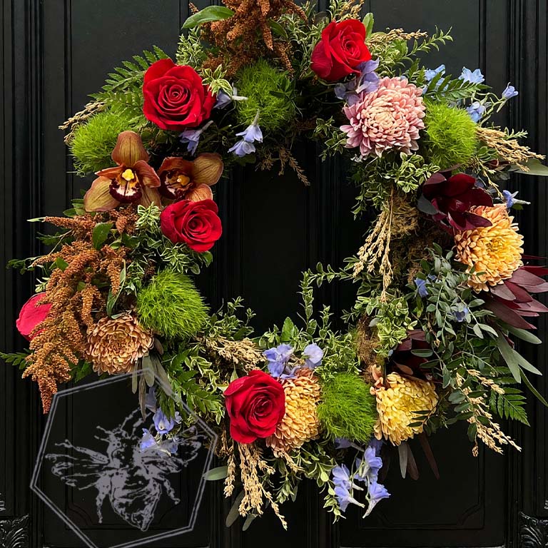 Colorful memorial wreath featuring red roses