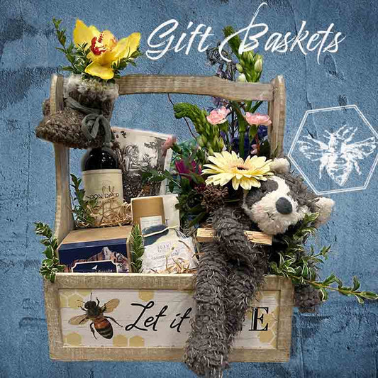 Custom gift basket featuring floral accents and all of your favorite goodies and gifts from The B Nest Studios
