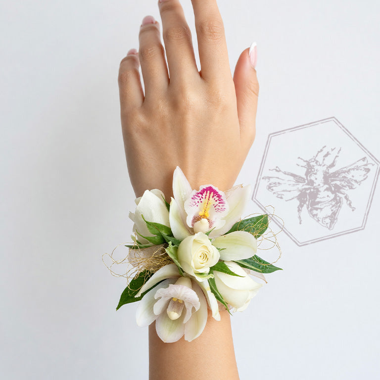 Wrist corsage featuring white orchids and roses