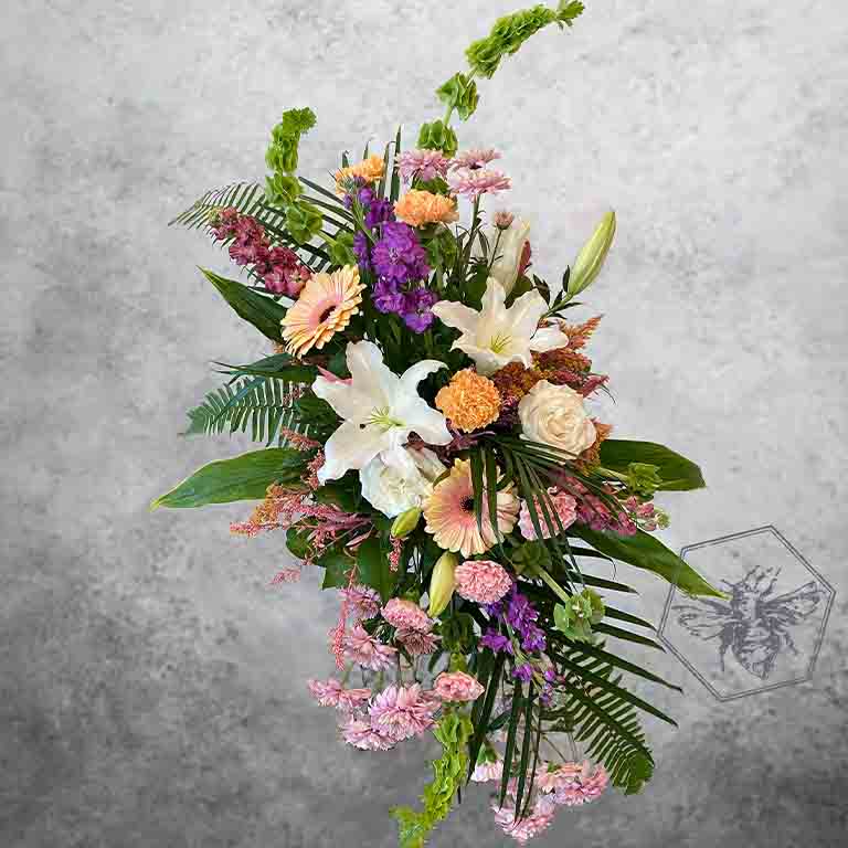 Memorial standing spray that is hand-crafted with absolute care and dignity by our design team, using premium, high-quality blooms to create a stunning, reverent focal piece that honors a unique life and legacy.