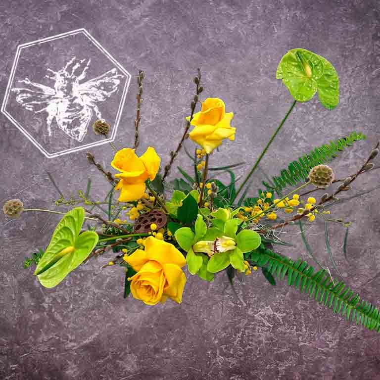 Modern arranged flowers with anthurium, roses fern, pussy willows and orchids with complimentary greenery in a ceramic pot