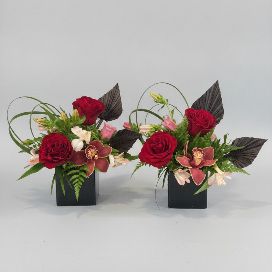 Two luxurious romantic floral arrangements with red roses and greenery on a gray background