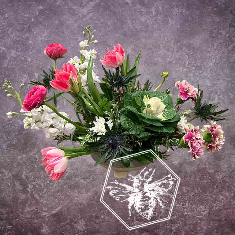 Fresh spring flowers creatively arranged in a ceramic pot with a modern style and luxurious tone with elevated care to every detail 