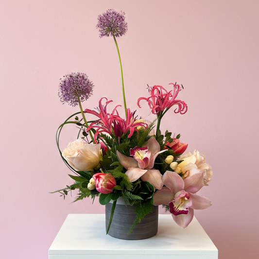 romantic creative floral celebration with roses mini cymbidium orchids Noreen lilies tulips and allium