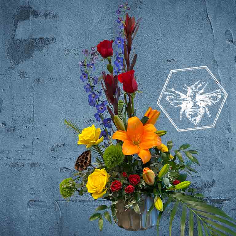 Premium modern arranged designers choice lilies with a creative sophistication and luxurious natural beauty with tiger lilies and red roses