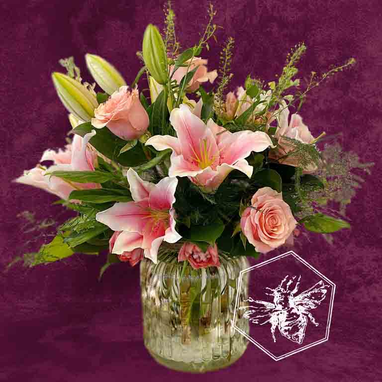 Premium fresh roses and luxurious lilies with complimentary florals elegantly arranged 