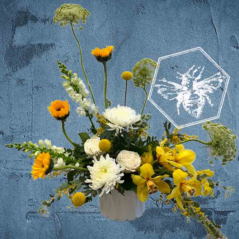 All of the colors of love wrapped up in modern luxury fresh floral creative brilliance featuring yellow orchids, white mums, sunflowers and queen Anne's lace