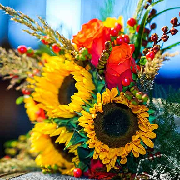 Luxurious bouquet of hand tied fresh cut florals for any occasion with sunflowers and roses