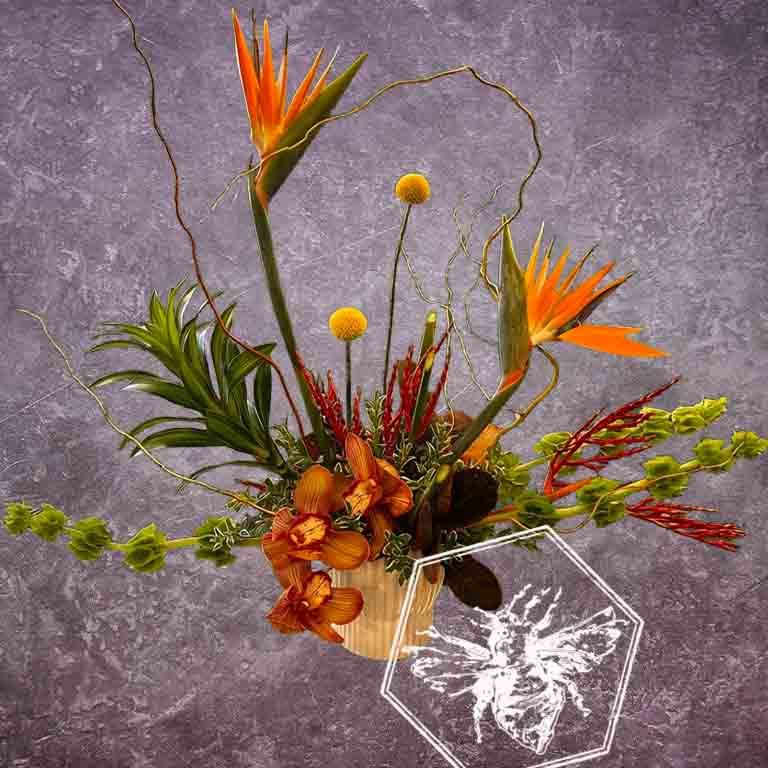 Creative fresh modern arranged tropical birds of paradise arranged with an assortment of complimentary flowers with greens and beautiful elevated accents