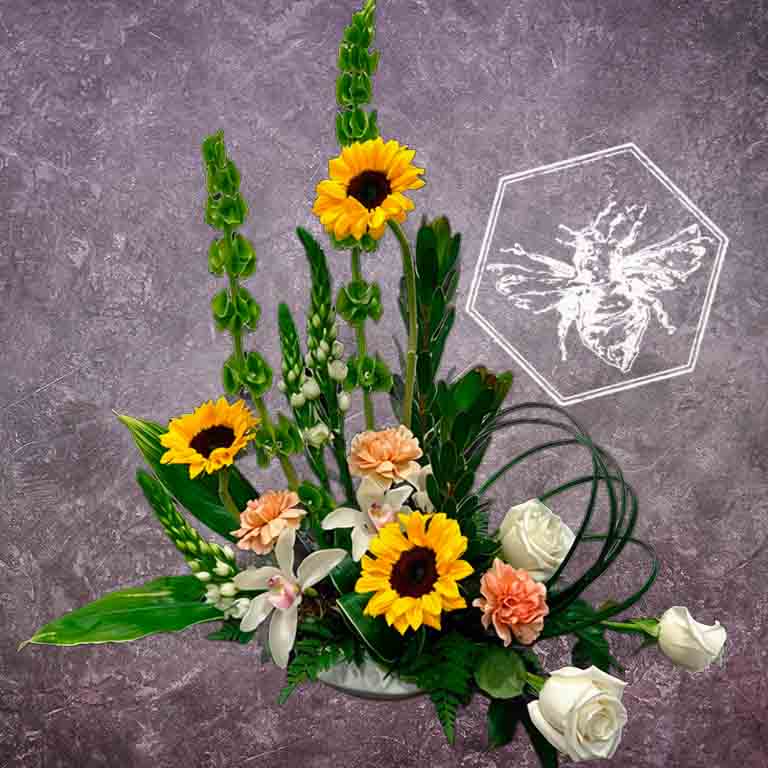 Luxurious modern arranged sunflowers elevated vertical greenery, white star, white mini orchids, roses, carnations and bells of Ireland.