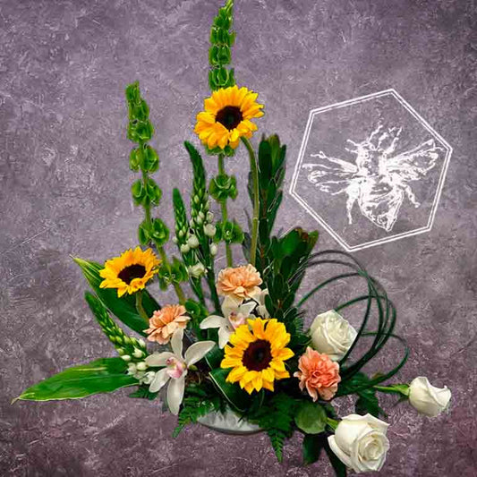Luxurious modern arranged sunflowers elevated vertical greenery, white star, white mini orchids, roses, carnations and bells of Ireland.