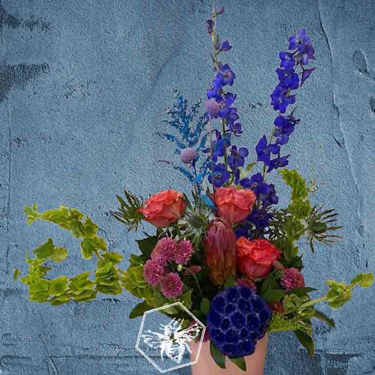 Modern seasonal flower arrangement with elevated feel and luxurious artisanal tone creatively and carefully crafted from the finest flowers and textures representing the season of the year 