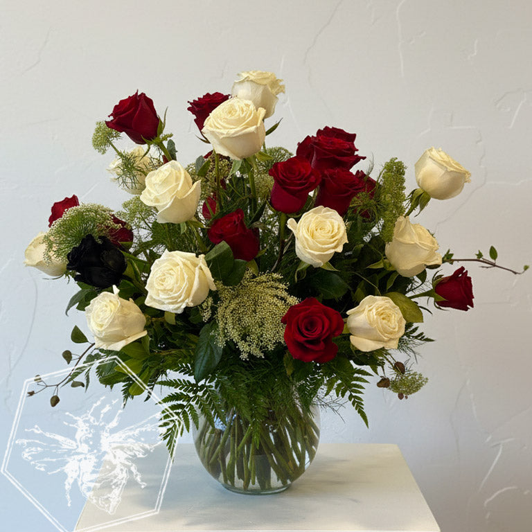 Black roses in a vase with a red heart-shaped watercolor design on a gray background.