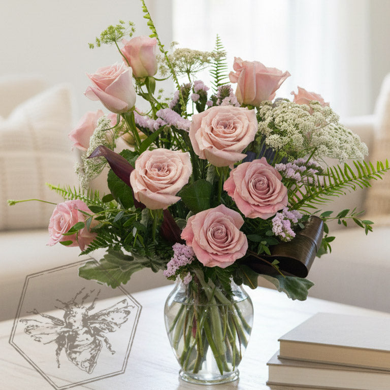 Black roses in a vase with a red heart-shaped watercolor design on a gray background.