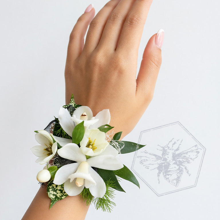 Wrist corsage with white orchids and greens