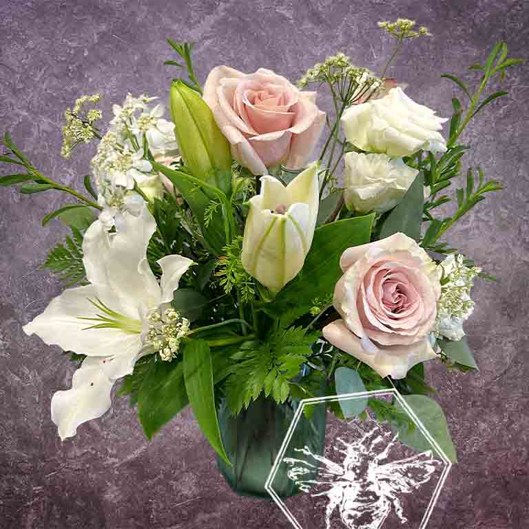 Premium fresh roses and luxurious lilies with complimentary florals elegantly arranged 